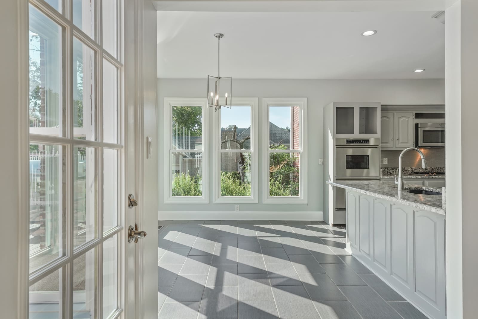 HDR photo of a renovated kitchen seen through open French doors