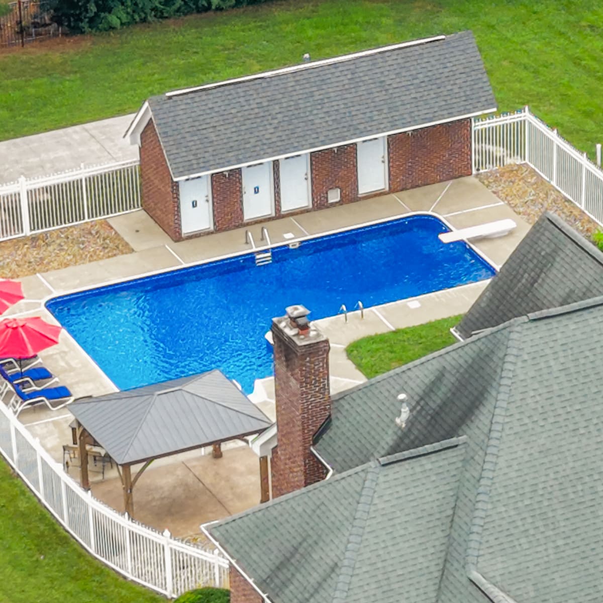 Overhead drone detail of the pool, pool house, and gazebo