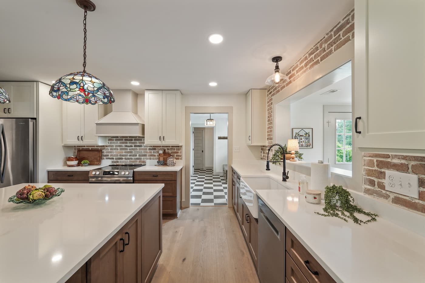 HDR photo of a kitchen with a white island and stained-glass pendant lights