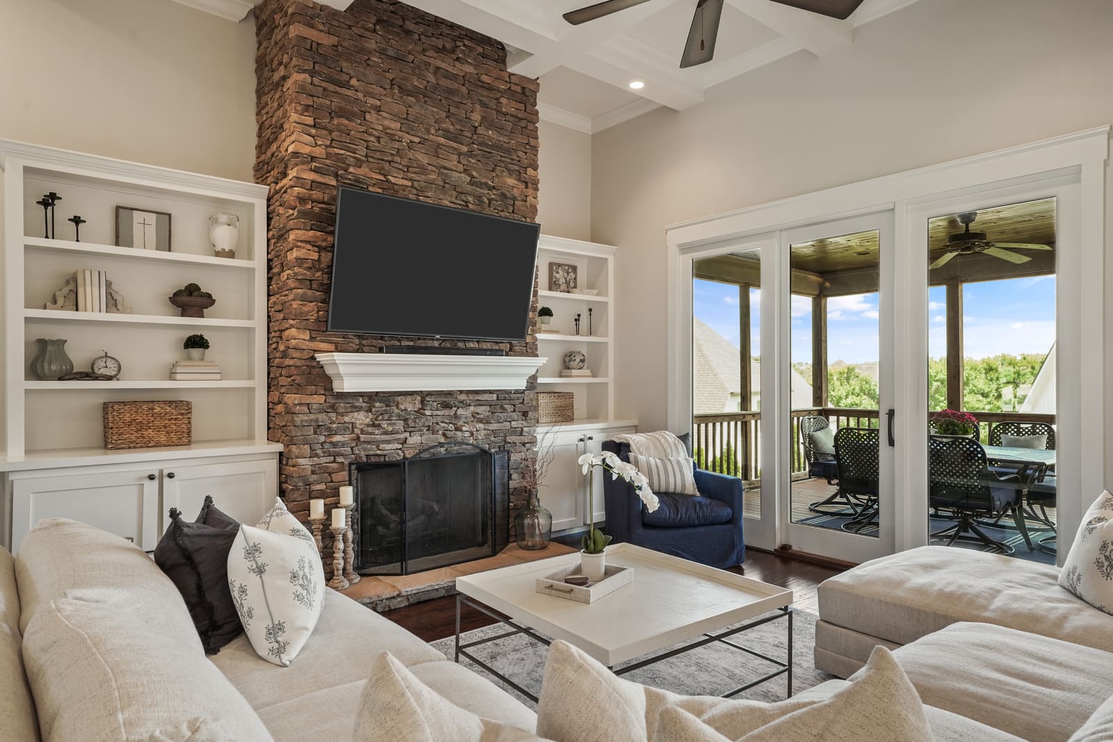 HDR photo of a living room with a brick fireplace and built-in shelving — listing photography by Visual Samples